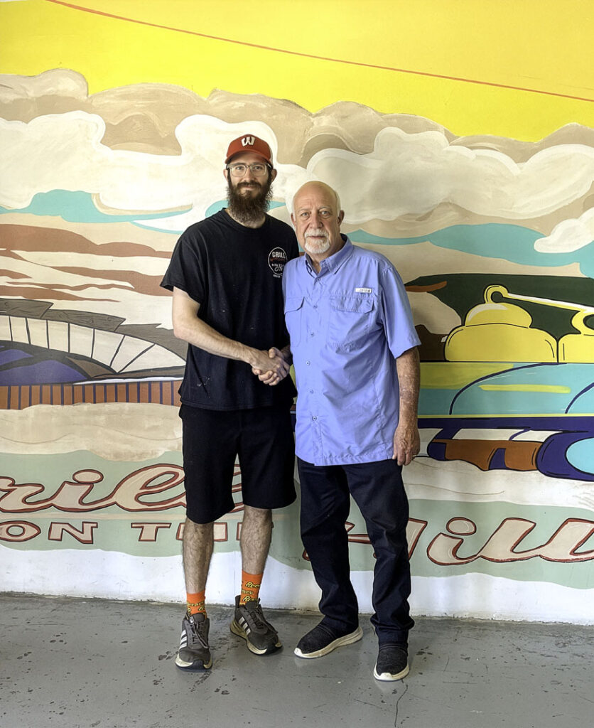 Brandon Hudson shakes hands with Westmoreland Mayor David Leath