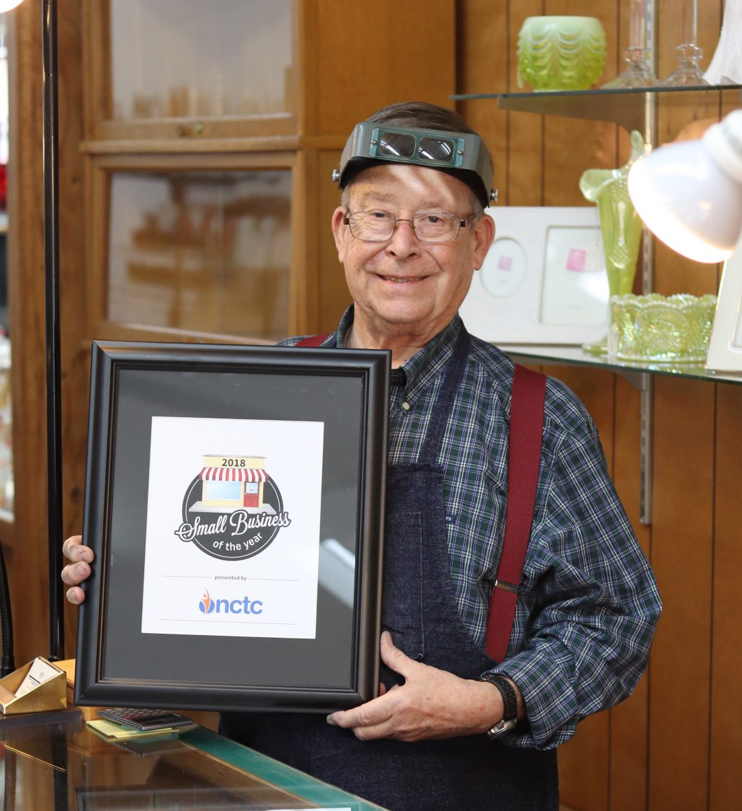 Stanley Johnson holding the Small Business of the Year award